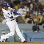 
              Los Angeles Dodgers' Justin Turner hits a home run during the fourth inning of a baseball game against the San Diego Padres Thursday, Sept. 30, 2021, in Los Angeles. (AP Photo/Ashley Landis)
            