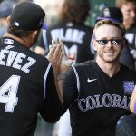 
              Colorado Rockies' Trevor Story, front right, celebrates his three-run home run with Carlos Estevez (54) and others in the dugout during the fourth inning of a baseball game against the Washington Nationals, Saturday, Sept. 18, 2021, in Washington. (AP Photo/Nick Wass)
            