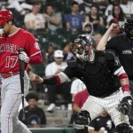 
              Chicago White Sox catcher Yasmani Grandal, center, tags out Los Angeles Angels' Shohei Ohtani after a dropped third strike, as home plate umpire Bill Welke makes the call during the ninth inning of a baseball game Tuesday, Sept. 14, 2021, in Chicago. The White Sox won 9-3. (AP Photo/Charles Rex Arbogast)
            