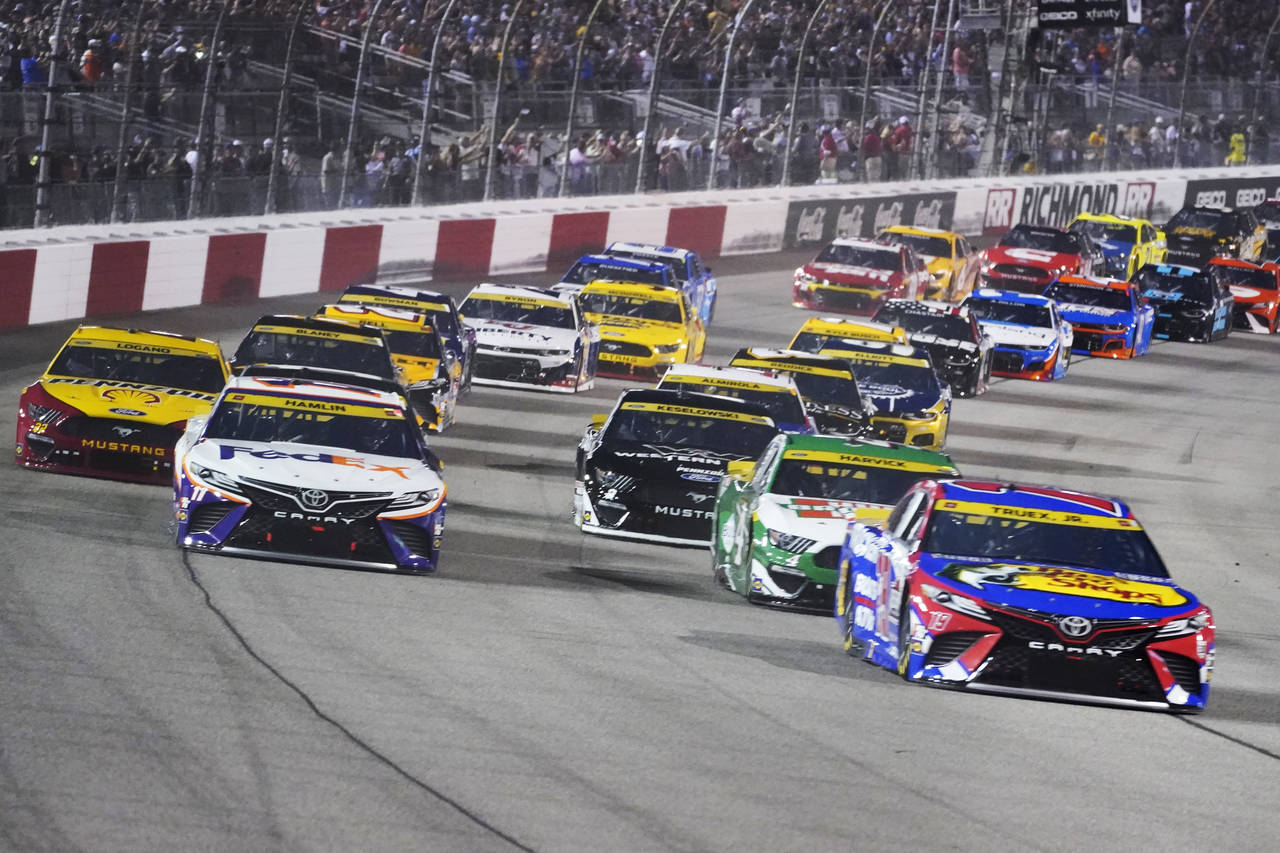 Denny Hamlin (11) and Martin Truex Jr., (19) lead the field st the start of the NASCAR Cup series a...