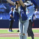 
              Canadian Olympian Penny Oleksiak throws out the ceremonial first pitch before the start of a baseball game between the Toronto Blue Jays and the Minnesota Twins in Toronto on Saturday, Sept. 18, 2021. (Jon Blacker/The Canadian Press via AP)
            