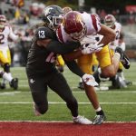 
              Southern California wide receiver Drake London, right, carries the ball for a touchdown while defended by Washington State linebacker Jahad Woods during the second half of an NCAA college football game, Saturday, Sept. 18, 2021, in Pullman, Wash. Southern California won 45-14. (AP Photo/Young Kwak)
            