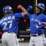 
              Toronto Blue Jays Marcus Semien, right, celebrates his solo home run off Minnesota Twins pitcher Bailey Ober with Vladimir Guerrero Jr. in the sixth inning of a baseball game, Friday, Sept. 24, 2021, in Minneapolis. (AP Photo/Jim Mone)
            