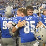 
              Memphis wide receiver Koby Drake (85) hugs quarterback Seth Henigan after an NCAA college football game against Mississippi State, Saturday, Sept. 18, 2021, in Memphis, Tenn. (AP Photo/John Amis)
            