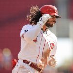 
              Cincinnati Reds' Jonathan India fixes his hair as he runs the bases after hitting a two-run home run during the seventh inning of a baseball game against the Pittsburgh Pirates in Cincinnati, Monday, Sept. 27, 2021. (AP Photo/Aaron Doster)
            