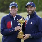 
              Team USA captain Steve Stricker and Team USA's Dustin Johnson hold the Ryder Cup during a practice day at the Ryder Cup at the Whistling Straits Golf Course Wednesday, Sept. 22, 2021, in Sheboygan, Wis. (AP Photo/Charlie Neibergall)
            
