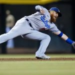 
              Los Angeles Dodgers third baseman Justin Turner makes a diving stop on a grounder hit by Arizona Diamondbacks' Carson Kelly before throwing to first base for the out during the eighth inning of a baseball game Saturday, Sept. 25, 2021, in Phoenix. The Diamondbacks defeated the Dodgers 7-2. (AP Photo/Ross D. Franklin)
            