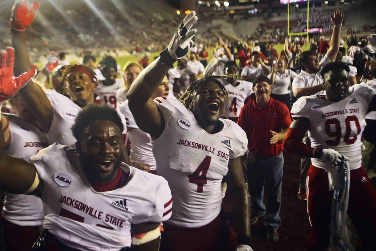 Jacksonville State players celebrate after a 20-17 win in an NCAA college football game against Flo...