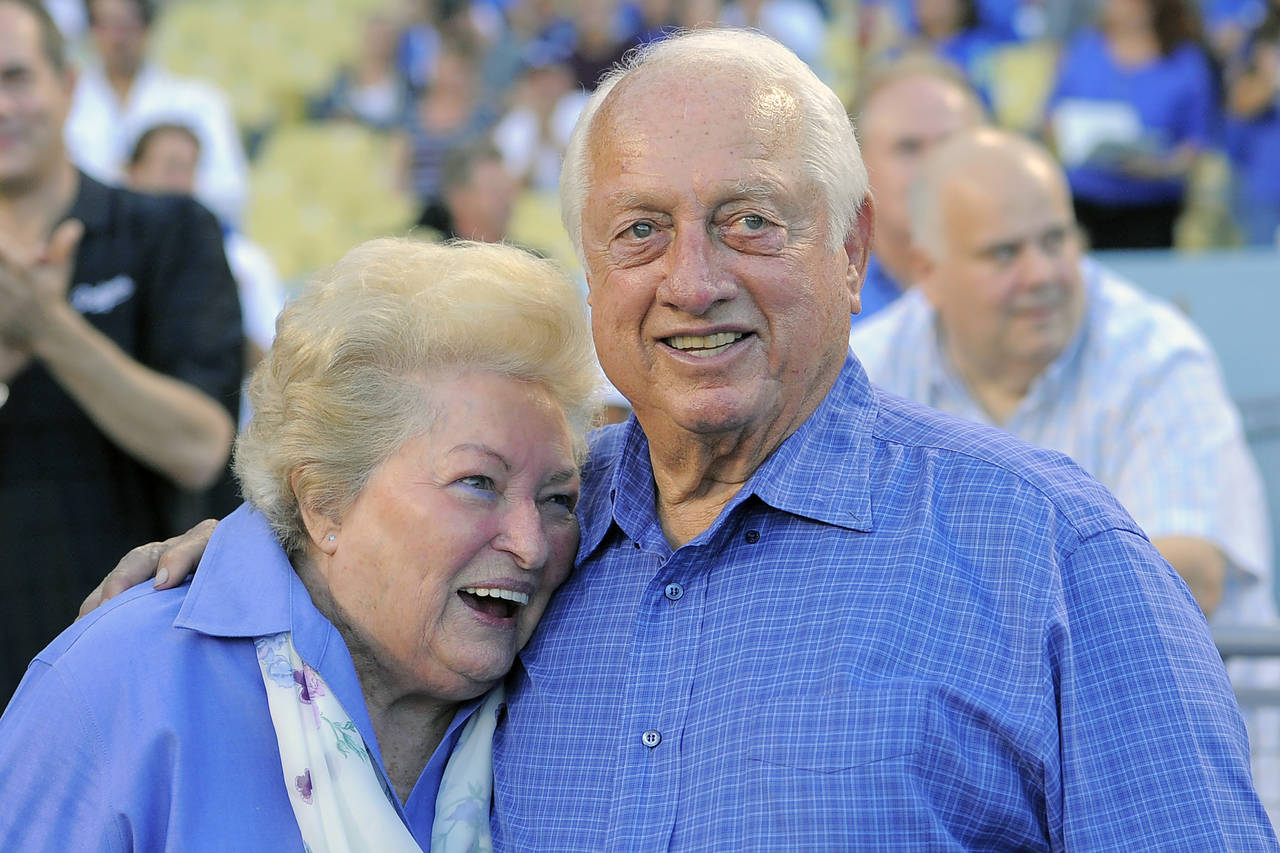 FILE - Tommy Lasorda and his wife Jo hug as they watch a video tribute to Tommy prior to the Los An...