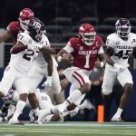 
              Arkansas quarterback KJ Jefferson (1) finds running room as Texas A&M defensive back Antonio Johnson (27) and linebacker Edgerrin Cooper (45) give chase in the first half of an NCAA college football game in Arlington, Texas, Saturday, Sept. 25, 2021. (AP Photo/Tony Gutierrez)
            