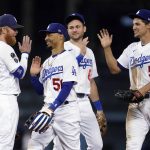 
              Los Angeles Dodgers' Justin Turner, Mookie Betts, Trea Turner and Corey Seager, from left, celebrate the team's 8-4 win over the Arizona Diamondbacks in a baseball game Tuesday, Sept. 14, 2021, in Los Angeles. (AP Photo/Marcio Jose Sanchez)
            