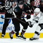 
              Arizona Coyotes center Travis Boyd (72) battles with Los Angeles Kings left wing Carl Grundstrom (91) for the puck during the first period of a preseason NHL hockey game Monday, Sept. 27, 2021, in Glendale, Ariz. (AP Photo/Ross D. Franklin)
            
