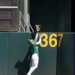 
              Oakland Athletics right fielder Chad Pinder cannot catch a home run hit by Seattle Mariners' Mitch Haniger during the sixth inning of a baseball game in Oakland, Calif., Thursday, Sept. 23, 2021. (AP Photo/Jeff Chiu)
            
