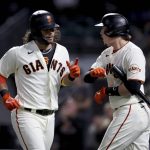 
              San Francisco Giants' Brandon Crawford, left, is congratulated by teammate Wilmer Flores after hitting a home run against the Arizona Diamondbacks during the fourth inning of a baseball game in San Francisco, Thursday, Sept. 30, 2021. (AP Photo/Jed Jacobsohn)
            