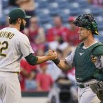 
              Oakland Athletics relief pitcher Lou Trivino, left, and catcher Yan Gomes celebrate a win in the 10th inning of a baseball game against the Los Angeles Angels, Sunday, Sept. 19, 2021, in Anaheim, Calif. (AP Photo/Jae C. Hong)
            