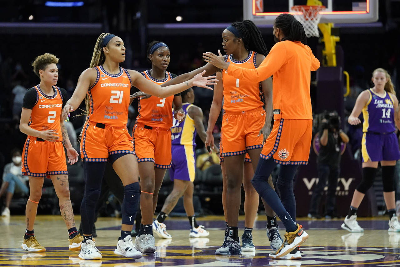 The Connecticut Sun celebrate a 75-57 win over the Los Angeles Sparks after their WNBA basketball g...