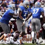 
              Memphis defensive lineman Maurice White (4) celebrates with teammates after sacking Mississippi State quarterback Will Rogers III (2) during an NCAA college football game Saturday, Sept. 18, 2021, in Memphis, Tenn. (Patrick Lantrip/Daily Memphian via AP)
            