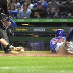 
              Chicago Cubs' Rafael Ortega (66) scores as Pittsburgh Pirates catcher Jacob Stallings, left, applies a late tag during the second inning of a baseball game in Pittsburgh, Thursday, Sept. 30, 2021. (AP Photo/Philip G. Pavely)
            