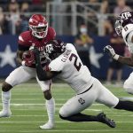 
              Arkansas running back Trelon Smith, left, is stopped by Texas A&M defensive lineman Micheal Clemons (2) on a carry in the second half of an NCAA college football game in Arlington, Texas, Saturday, Sept. 25, 2021. (AP Photo/Tony Gutierrez)
            