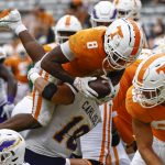 
              Tennessee running back Tiyon Evans (8) dives in for a touchdown as he's hit by Tennessee Tech linebacker Seth Carlisle (18) during the second half of an NCAA college football game Saturday, Sept. 18, 2021, in Knoxville, Tenn. (AP Photo/Wade Payne)
            