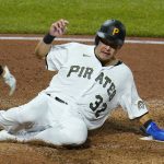 
              Pittsburgh Pirates' Yoshi Tsutsugo scores on a triple by Bryan Reynolds off Chicago Cubs relief pitcher Adam Morgan during the sixth inning of a baseball game in Pittsburgh, Wednesday, Sept. 29, 2021. (AP Photo/Gene J. Puskar)
            