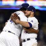 
              Los Angeles Dodgers relief pitcher Kenley Jansen, left, hugs Max Muncy after the Dodgers' 8-4 win over the Arizona Diamondbacks in a baseball game Tuesday, Sept. 14, 2021, in Los Angeles. (AP Photo/Marcio Jose Sanchez)
            