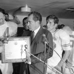 
              FILE - In this Dec. 6, 1969, file photo, President Richard Nixon presents a plaque to Texas football coach Darrell Royal, naming the Longhorns the No. 1 college football team in college football as linebacker Glen Halsell (67) and quarterback James Street (16) watch. The Longhorns' fourth-quarter comeback led by Street erased Arkansas' 14-0 lead and sent Texas unbeaten into the Cotton Bowl, but it wasn't even the memorable part of the event for many who remember it. Nixon arrived by helicopter to attend the game, and after he declared the Longhorns national champions —- before they even played their bowl game. (AP Photo/File)
            