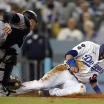 
              Los Angeles Dodgers' Gavin Lux, right, is tagged out at home plate by Arizona Diamondbacks catcher Carson Kelly after a sacrifice fly by Mookie Betts during the fourth inning of a baseball game Monday, Sept. 13, 2021, in Los Angeles. (AP Photo/Marcio Jose Sanchez)
            