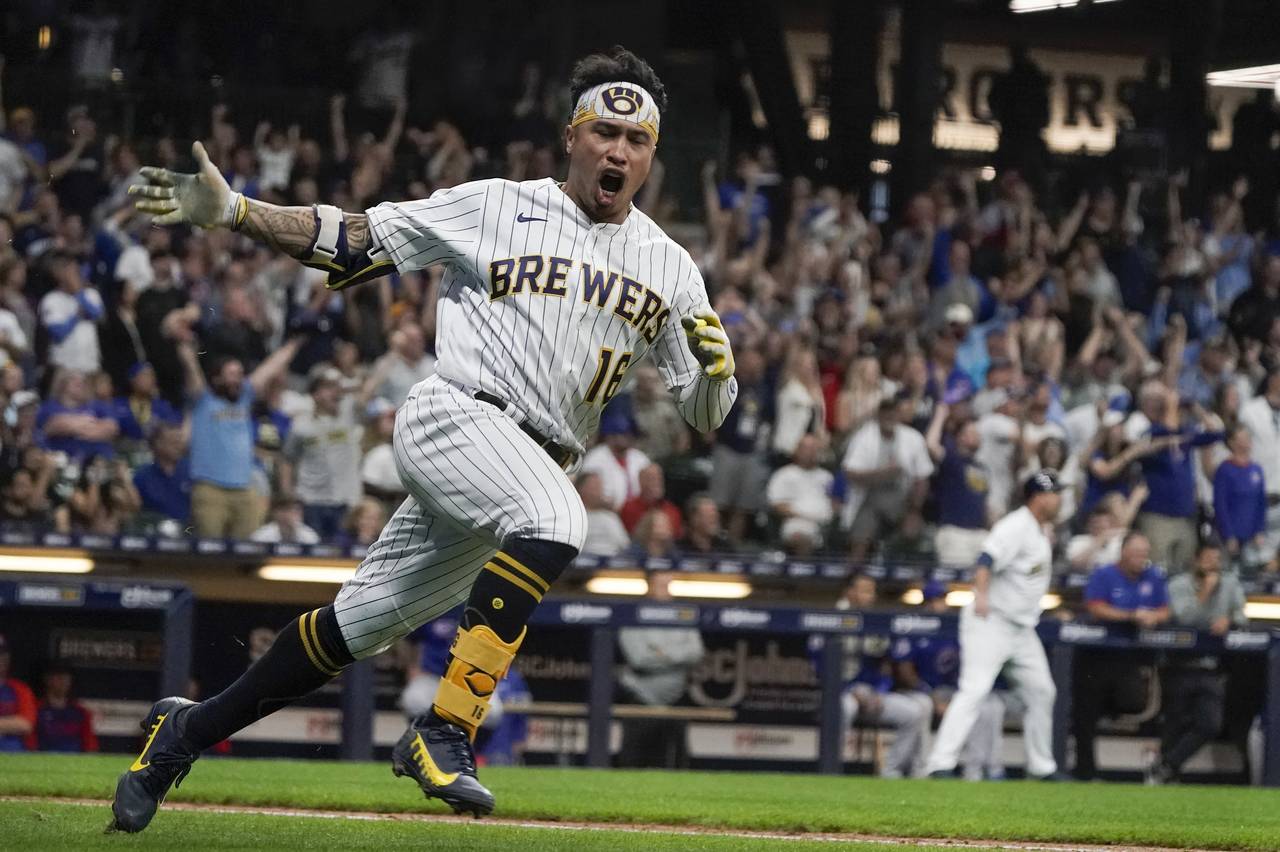 Milwaukee Brewers' Kolten Wong reacts after hitting a two-run scoring single during the eighth inni...