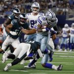 
              Dallas Cowboys running back Ezekiel Elliott (21) breaks a tackle attempt by Philadelphia Eagles safety Anthony Harris, bottom left, as he sprints to the end zone for a touchdown in the first half of an NFL football game in Arlington, Texas, Monday, Sept. 27, 2021. (AP Photo/Michael Ainsworth)
            