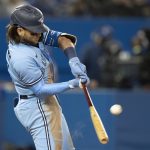 
              Toronto Blue Jays shortstop Bo Bichette (11) hits the game winning solo home run during the eighth inning  of a baseball game against the New York Yankees in Toronto on Wednesday Sept. 29, 2021. (Frank Gunn/The Canadian Press via AP)
            