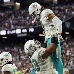 
              Miami Dolphins offensive guard Robert Hunt (68) holds up wide receiver Will Fuller (3) after Fuller scored a two-point conversion against the Las Vegas Raiders during the second half of an NFL football game, Sunday, Sept. 26, 2021, in Las Vegas. (AP Photo/Rick Scuteri)
            