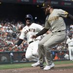 
              San Francisco Giants' Kris Bryant, left, slides home to score past San Diego Padres pitcher Austin Adams during the sixth inning of a baseball game in San Francisco, Thursday, Sept. 16, 2021. (AP Photo/Jeff Chiu)
            