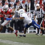 
              Ohio State running back TreVeyon Henderson, left, cuts upfield against Tulsa defensive back Travon Fuller during the second half of an NCAA college football game Saturday, Sept. 18, 2021, in Columbus, Ohio. (AP Photo/Jay LaPrete)
            