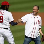 
              Doug Emhoff, second gentleman of the United States, right, shakes hands with Washington Nationals first baseman Josh Bell (19) after he threw out the ceremonial first pitch before a baseball game between the Nationals and the Colorado Rockies, Saturday, Sept. 18, 2021, in Washington. (AP Photo/Nick Wass)
            