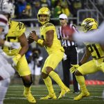 
              Oregon quarterback Ty Thompson, center, looks for a receiver during the fourth quarter of an NCAA college football game against Stony Brook, Saturday, Sept. 18, 2021, in Eugene, Ore. (AP Photo/Andy Nelson)
            