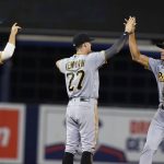 
              Pittsburgh Pirates shortstop Cole Tucker, right, celebrates with Kevin Newman (27) and Hoy Park (68) at the end of the team's baseball game against the Miami Marlins, Saturday, Sept. 18, 2021, in Miami. The Pirates won 6-3. (AP Photo/Marta Lavandier)
            