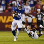 
              New York Giants running back Saquon Barkley (26) breaks away from Washington Football Team cornerback Bobby McCain (20) as he runs with the ball during the first half of an NFL football game, Thursday, Sept. 16, 2021, in Landover, Md. (AP Photo/Alex Brandon)
            