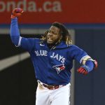 
              Toronto Blue Jays' Vladimir Guerrero Jr. gestures toward the dugout after hitting an RBI-double in the fifth inning of a baseball game against the New York Yankees in Toronto, Thursday, Sept. 30, 2021. (Jon Blacker/The Canadian Press via AP)
            
