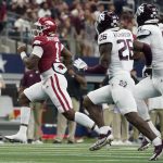 
              Arkansas quarterback KJ Jefferson (1) runs the ball as Texas A&M defensive back Demani Richardson (26) and defensive lineman DeMarvin Leal (8) give chase in the first half of an NCAA college football game in Arlington, Texas, Saturday, Sept. 25, 2021. (AP Photo/Tony Gutierrez)
            