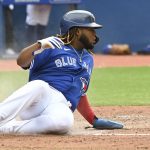 
              Toronto Blue Jays' Vladimir Guerrero Jr. slides safely into home following a single by Teoscar Hernandez during the fifth inning of a baseball game against the Tampa Bay Rays, Wednesday, Sept. 15, 2021 in Toronto. (Jon Blacker/The Canadian Press via AP)
            