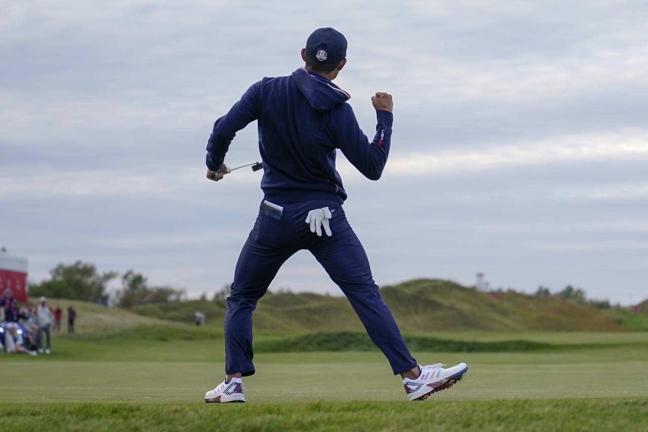 Team USA's Collin Morikawa makes a putt on the 15th hole during a four-ball match the Ryder Cup at ...