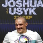 
              Oleksandr Usyk of Ukraine smiles during a press conference after winning the WBA (Super), WBO and IBF boxing title bout against Anthony Joshua of Britain at the Tottenham Hotspur Stadium in London Saturday Sept. 25, 2021. (Nick Potts/PA via AP)
            
