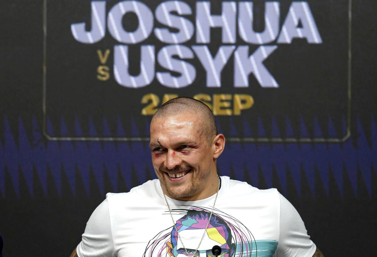 Oleksandr Usyk of Ukraine smiles during a press conference after winning the WBA (Super), WBO and I...