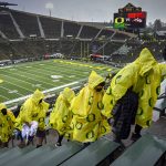 
              Oregon fans head to cover in Autzen Stadium due to a passing thunderstorm before Oregon plays Stony Brook in an NCAA college football game Saturday, Sept. 18, 2021, in Eugene, Ore. (AP Photo/Andy Nelson)
            