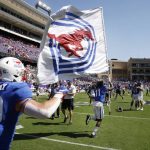 
              SMU wide receiver Rashee Rice (11), followed by linebacker Brian Holloway (30) runs the SMU flag to midfield after they defeated TCU a NCAA football game in Fort Worth, Texas, Saturday, Sept. 25, 2021. (AP Photo/Michael Ainsworth)
            