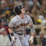 
              San Francisco Giants' Mike Yastrzemski watches his sacrifice fly ball hit during the sixth inning of a baseball game against the San Diego Padres, Tuesday, Sept. 21, 2021, in San Diego. The Giants' Brandon Crawford scored from third on the play. (AP Photo/Gregory Bull)
            