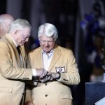 
              Dallas Cowboys team owner Jerry Jones honors former coach Jimmy Johnson for his Hall Of Fame induction during a halftime ceremony of an NFL football game between the Philadelphia Eagles and Dallas Cowboys in Arlington, Texas, Monday, Sept. 27, 2021. (AP Photo/Ron Jenkins)
            