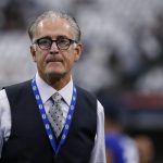 
              FILE - In this Sept. 8, 2019, file photo, former NFL official Mike Pereira walks across the field before a football game between the New York Giants and the Dallas Cowboys in Arlington, Texas. Battlefields2Ballfields, founded by Pereira, is in its fifth year of promoting officiating by awarding scholarships to former military members interested in working in a variety of sports. Thus far, the organization has given out more than 550 scholarship and has more than 300 active officials. They work in such sports as football, basketball, baseball, softball, soccer, volleyball, wrestling and track and field. (AP Photo/Michael Ainsworth, File)
            