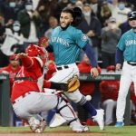 SEATTLE, WASHINGTON - OCTOBER 01: Abraham Toro #13 of the Seattle Mariners scores on a double by Jarred Kelenic #10 during the second inning against the Los Angeles Angels at T-Mobile Park on October 01, 2021 in Seattle, Washington. (Photo by Steph Chambers/Getty Images)